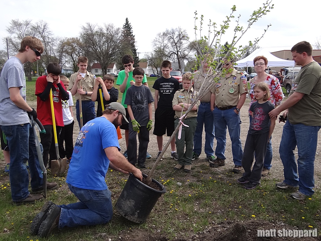 City Forester Doug Wiles demonstrates tree planting techniques to Boy Scouts